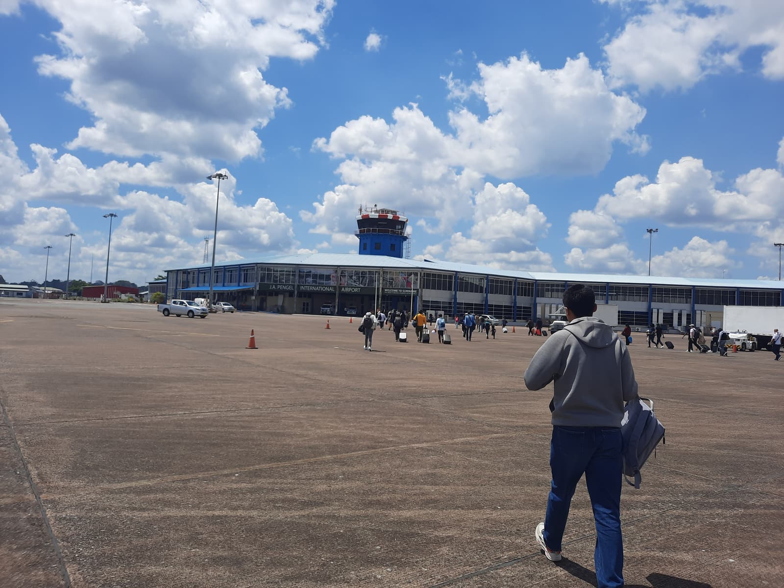Passengers walking to the terminal at Johan Adolf Pengel International Airport